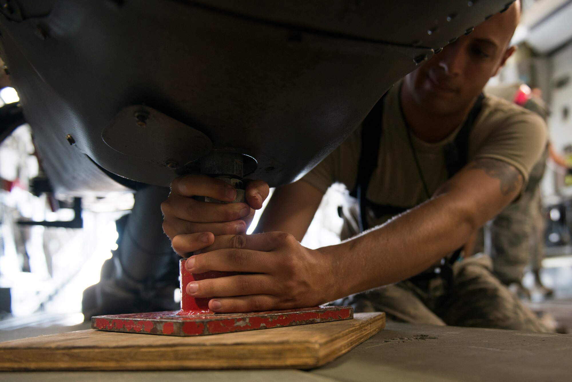 U.S. Air Force Staff Sgt. Josh Jaynes, 41st Helicopter Maintenance Unit HH-60G Pave Hawk crew chief, secures a jack underneath an HH-60 inside of a C-17 Globemaster III during rapid-on, rapid-off training July 30, 2015, at Moody Air Force Base, Ga. The 41st HMU teamed up with the 300th Airlift Squadron from Charleston AFB, S.C., to train on deployment transportation of HH-60s. (U.S. Air Force photo by Airman 1st Class Dillian Bamman/Released)