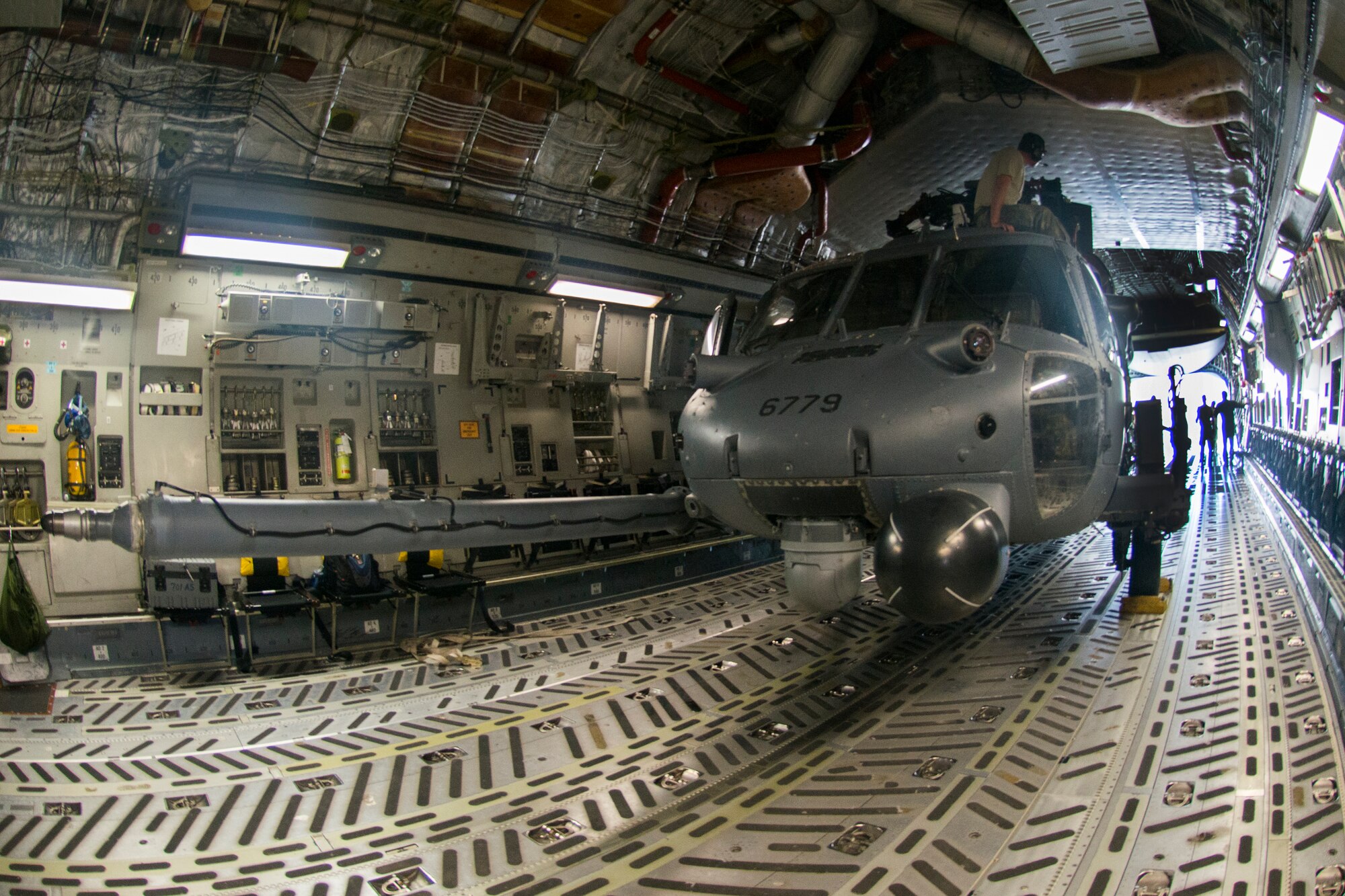An HH-60G Pave Hawk rests inside a C-17 Globemaster III before flight during rapid-on, rapid-off training July 30, 2015, at Moody Air Force Base, Ga. Members of the 41st Helicopter Maintenance Unit loaded two HH-60s into a single C-17 for transport. (U.S. Air Force photo by Airman 1st Class Dillian Bamman/Released)