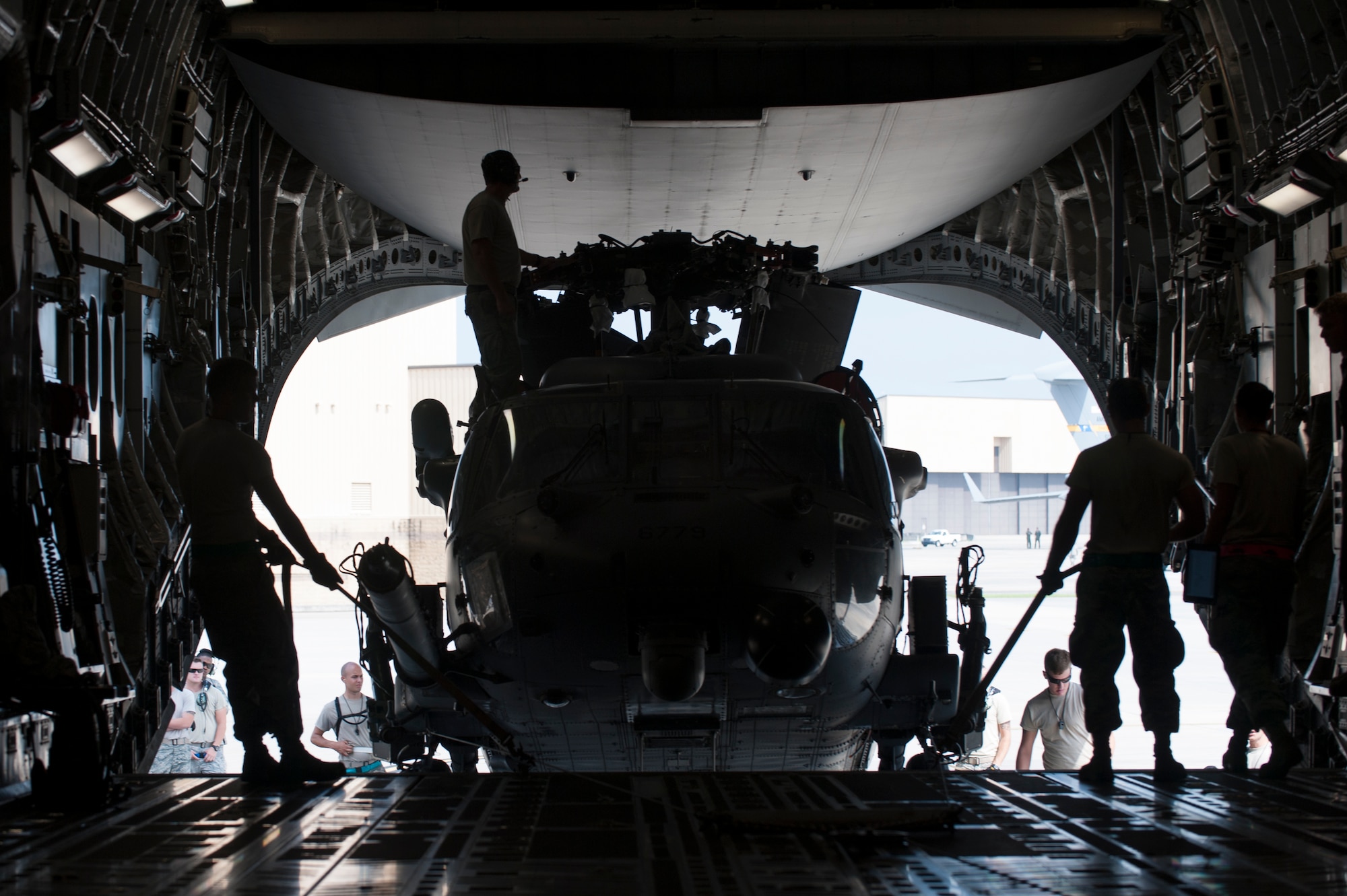 Members of the 41st Helicopter Maintenance Unit lift an HH-60G Pave Hawk onto a C-17 Globemaster III during rapid-on, rapid-off training July 30, 2015, at Moody Air Force Base, Ga. The C-17 aircraft holds the capability to transport two HH60s in a single flight. (U.S. Air Force photo by Airman 1st Class Dillian Bamman/Released)