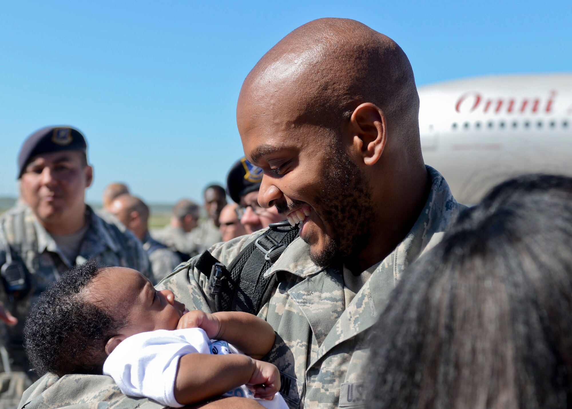 Senior Airman Cory, 28th Aircraft Maintenance Squadron crew chief, holds his son after returning home from a deployment, at Ellsworth Air Force Base, S.D., July 30, 2015. Cory was one of more than 350 Airmen who served more than six months in support of Operation Freedom’s Sentinel and Operation Inherent Resolve. (U.S. Air Force photo by Senior Airman Anania Tekurio/Released)