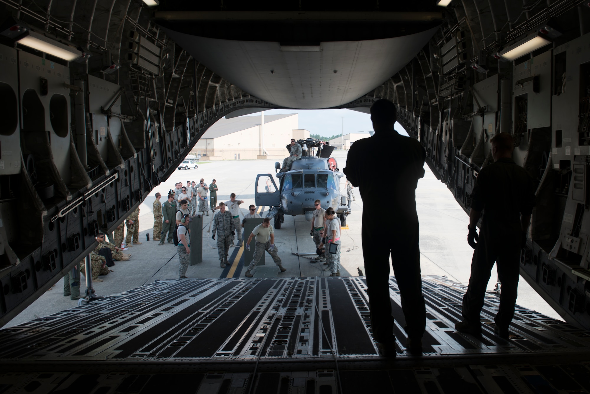 Loadmasters from Charleston Air Force Base, S.C., and members of the 41st Helicopter Maintenance Unit prepare to load an HH-60G Pave Hawk onto a C-17 Globemaster III during rapid-on, rapid-off training July 30, 2015, at Moody Air Force Base, Ga. The 41st HMU conducted the training to ensure the rescue mission readiness of the 23d Wing. (U.S. Air Force photo by Airman 1st Class Dillian Bamman/Released)