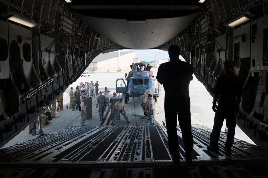 Loadmasters from Charleston Air Force Base, S.C., and members of the 41st Helicopter Maintenance Unit prepare to load an HH-60G Pave Hawk onto a C-17 Globemaster III during rapid-on, rapid-off training July 30, 2015, at Moody Air Force Base, Ga. The 41st HMU conducted the training to ensure the rescue mission readiness of the 23d Wing. (U.S. Air Force photo by Airman 1st Class Dillian Bamman/Released)