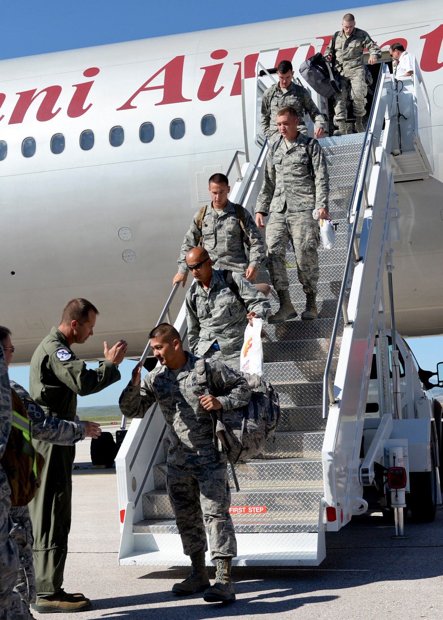 Col. Ty Neuman, 28th Bomb Wing vice commander, greets Airmen upon their return from deployment at Ellsworth Air Force Base, S.D., July 30, 2015. Base leaders welcomed more than 350 deployers who returned after serving about six months in support of Operation Freedom’s Sentinel and Operation Inherent Resolve in the U. S. Central Command area of responsibility. (U.S. Air Force photo by Senior Airman Anania Tekurio/Released) 