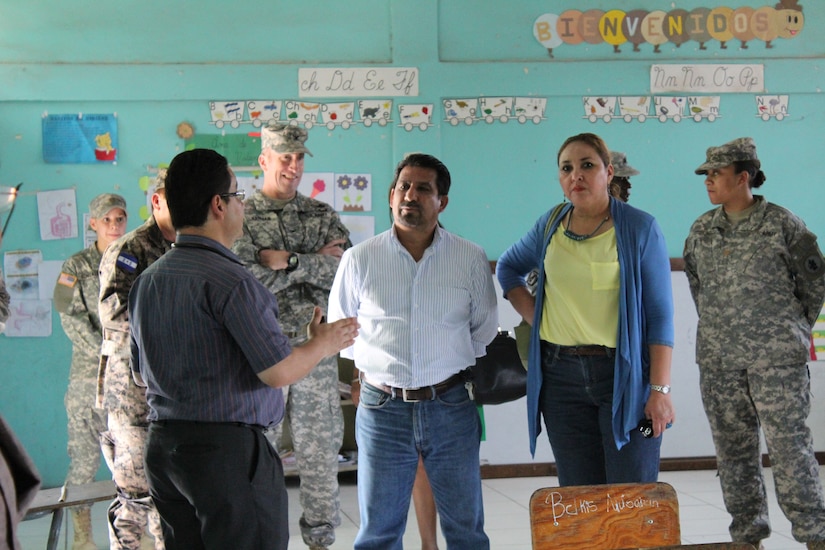 Dr. Carlos Durón (left), medical liaison for JTF-Bravo’s Medical Element, provides a tour of the facilities for Manuel Cartagena (center), Deputy Mayor of Comayagua, and Dr. Dolores Ortega (right), Honduran Ministry of Health regional representative, as he explains the different services provided during the Medical Readiness Training Exercise in the Ramon Ortega School located in Las Liconas, Comayagua, July 29, 2015. Each room in the school was divided into different services, to include a room for women’s health, a pharmacy, and a dental clinic.  (U.S. Army photo by Maria José Pinel) 