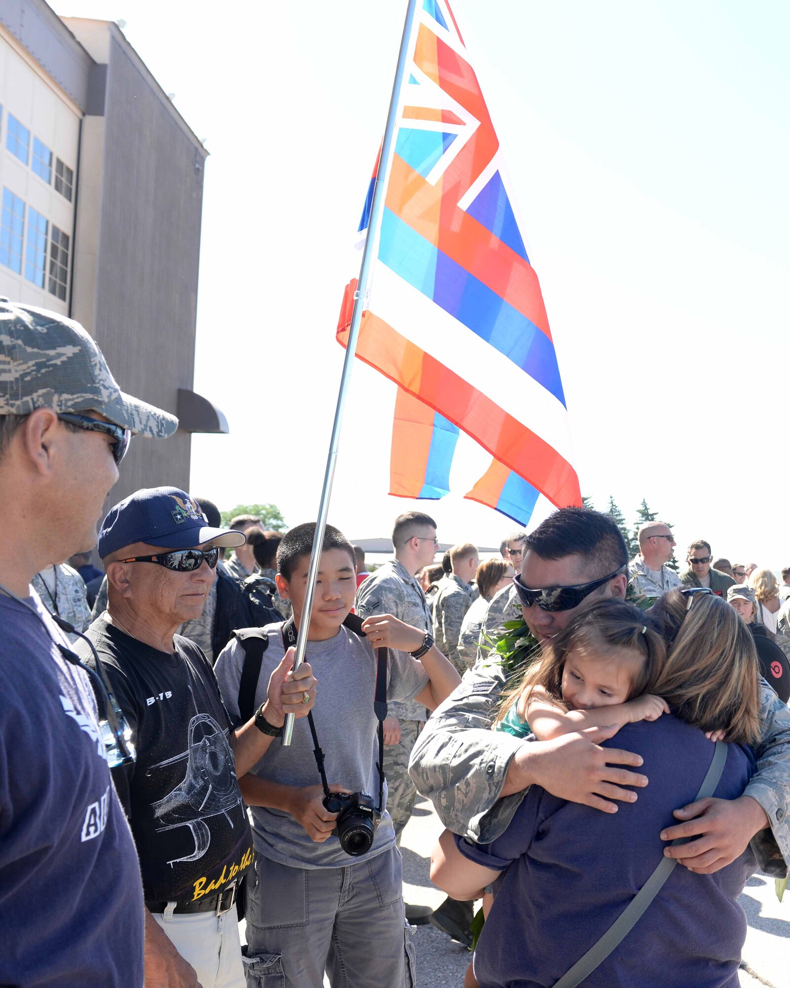 Senior Airman Kirk, 28th Munitions Squadron armament team member, hugs his family upon his return from a six-month deployment to Southwest Asia at Ellsworth Air Force Base, S.D., July 30, 2015.  To Kirks surprise, his family members traveled from Hawaii to welcome him home from deployment. (U.S. Air Force photo by Senior Airman Rebecca Imwalle/ Released)