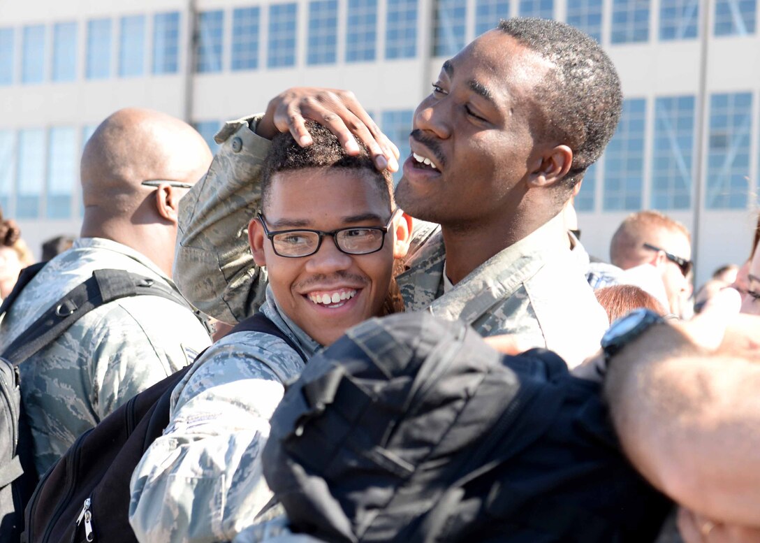 Airman 1st Class Joseph (left), 28th Maintenance Squadron repair reclamation technician, is greeted by A1C Royston Bedminster, 28th MXS non-destructive inspection technician, upon his return from deployment at Ellsworth Air Force Base, S.D., July 30, 2015. Friends, family members, co-workers and base leadership greeted Airmen following a six-month deployment to Southwest Asia in support of Operations Freedom’s Sentinel and Inherent Resolve. (U.S. Air Force photo by Senior Airman Rebecca Imwalle/ Released)