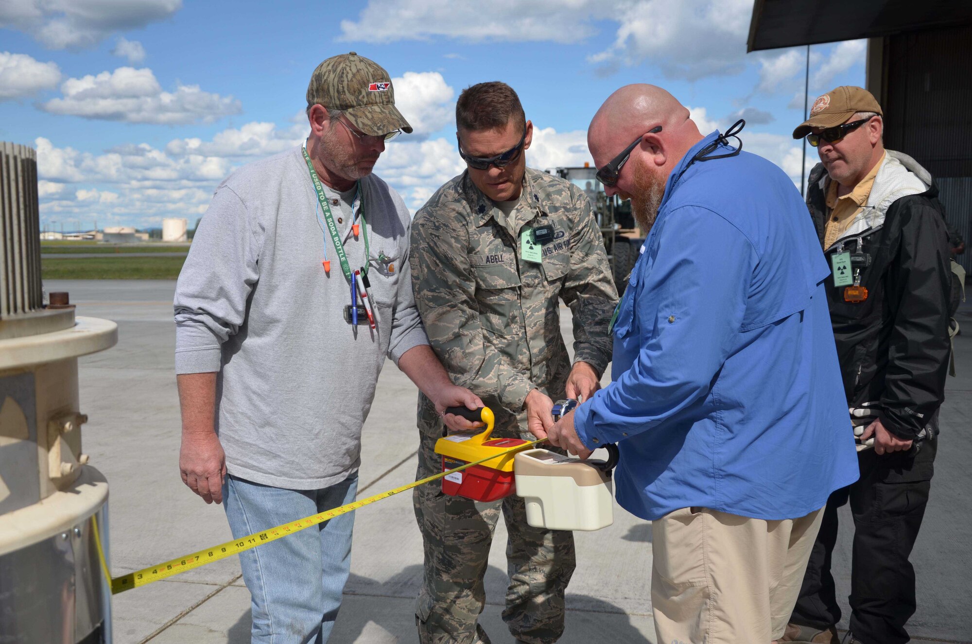 From left to right:  Chris Anthony, Lt. Col. Clint Abell and Charlie Mitchell conduct radiation dose rate measurements using an ion chamber as Air Force Technical Applications Center radiologic safety officer Mark Talbert observes.  Anthony and Mitchell, both with Air Force Radiologic Disposal and Abell, a member of the Air Force Inspection Agency, were on hand at Eielson AFB, Alaska, July 16, 2015, to ensure the safe and proper disposal of radiologic material from AFTAC's Detachment 460 on Burnt Mountain.  (U.S. Air Force photo by Susan A. Romano)