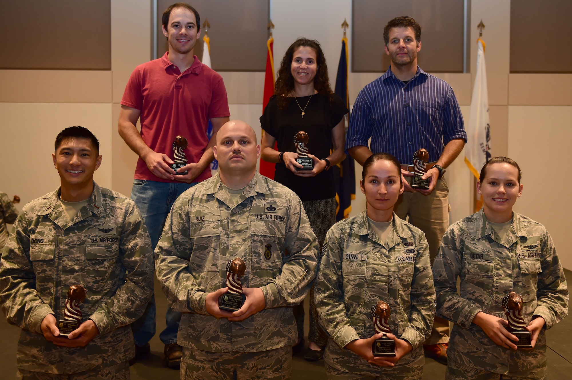 The 460th Space Wing quarterly award winners stand together July 30, 2015, at the Leadership Development Center on Buckley Air Force Base, Colo. The award winners were chosen because of their hard work and dedication in their work centers. (U.S. Air Force photo by Airman 1st Class Luke W. Nowakowski/Released)