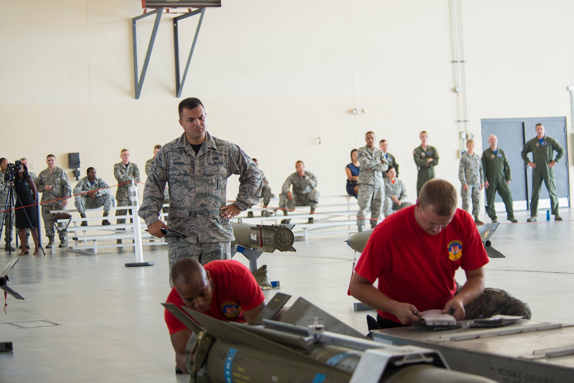 U.S. Air Force Tech. Sgt. Zachary Marquis, 23d Maintenance Group loading standardization crew member, evaluates competitors from the 75th Aircraft Maintenance Unit during the load crew of the quarter competition July 17, 2015, at Moody Air Force Base, Ga. Airmen from the weapons standardization section evaluate and teach loading procedures to the 74th, 75th Aircraft Maintenance Units and 41st Helicopter Maintenance Unit monthly. (U.S. Air Force photo by Airman 1st Class Ceaira Tinsley/Released)