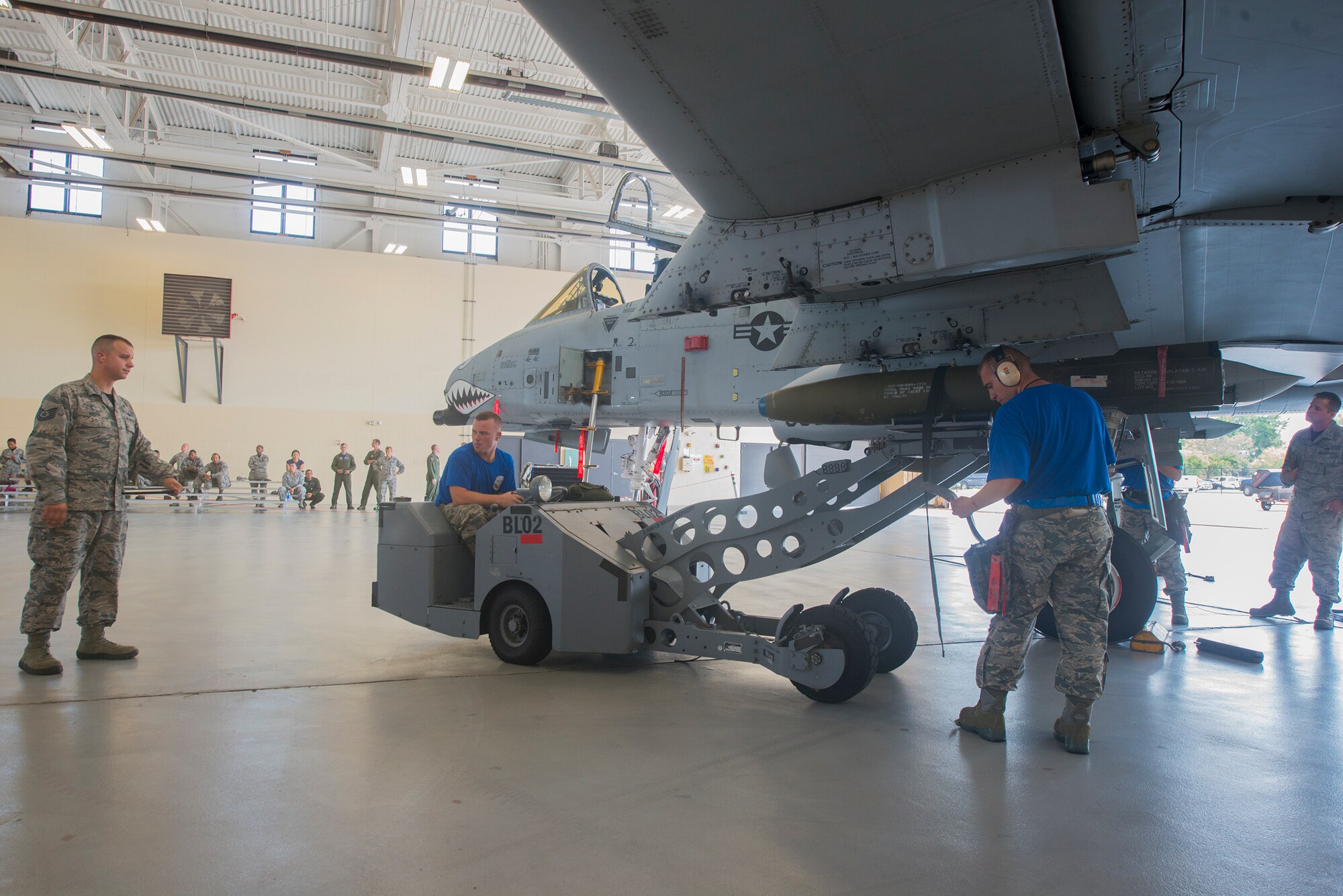 U.S. Air Force Tech. Sgt. Gregory Boggs, (left), 23d Maintenance Group loading standardization crew member, evaluates competitors from the 74th Aircraft Maintenance Unit during the load crew of the quarter competition July 17, 2015, at Moody Air Force Base, Ga. The weapons standardization section ensures all Airmen in the weapons community are certified and qualified to perform the mission. (U.S. Air Force photo by Airman 1st Class Ceaira Tinsley/Released)