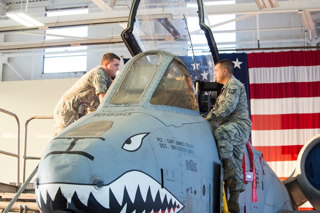U.S. Air Force Tech. Sgt. Zachary Marquis, 23d Maintenance Group loading standardization crew member, shows an A-10C Thunderbolt II to Capt. Zachary Garrett, 23d Aeromedical Dental Squadron general dentist, during a tour of the loadbarn July 29, 2015, at Moody Air Force Base, Ga. The loadbarn is a term used to describe the hanger where the weapons standardization flight Airmen teaches loading procedures and techniques. (U.S. Air Force photo by Airman 1st Class Ceaira Tinsley/Released)