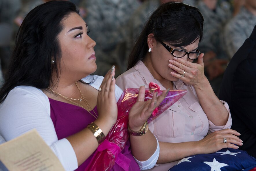 Chong Burgess, wife of U.S. Air Force Chief Master Sgt. Charles Burgess, retired 82nd Training Wing command chief, receives a U.S. flag during her husband’s retirement ceremony, July 31, 2015, at Sheppard Air Force Base, Texas. The Burgess family was honored during this ceremony as well in recognition for their continued support over the chief’s 28-year career. (U.S. Air Force photo by Senior Airman Kyle Gese/Released)