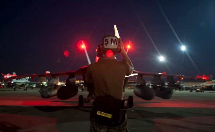 U.S. Navy Petty Officer 3rd Class Ryan Gosch, a plane captain assigned to Electronic Attack Squadron 138, Naval Air Station Whidbey Island, Wash., marshals the aircrew of an EA-18G Growler during Red Flag 15-3 at Nellis Air Force Base, Nev., July 28, 2015. Red Flag provides a series of intense scenarios for aircrew and ground personnel to increase their combat readiness and effectiveness for future missions. (U.S. Air Force photo by Airman 1st Class Mikaley Towle)