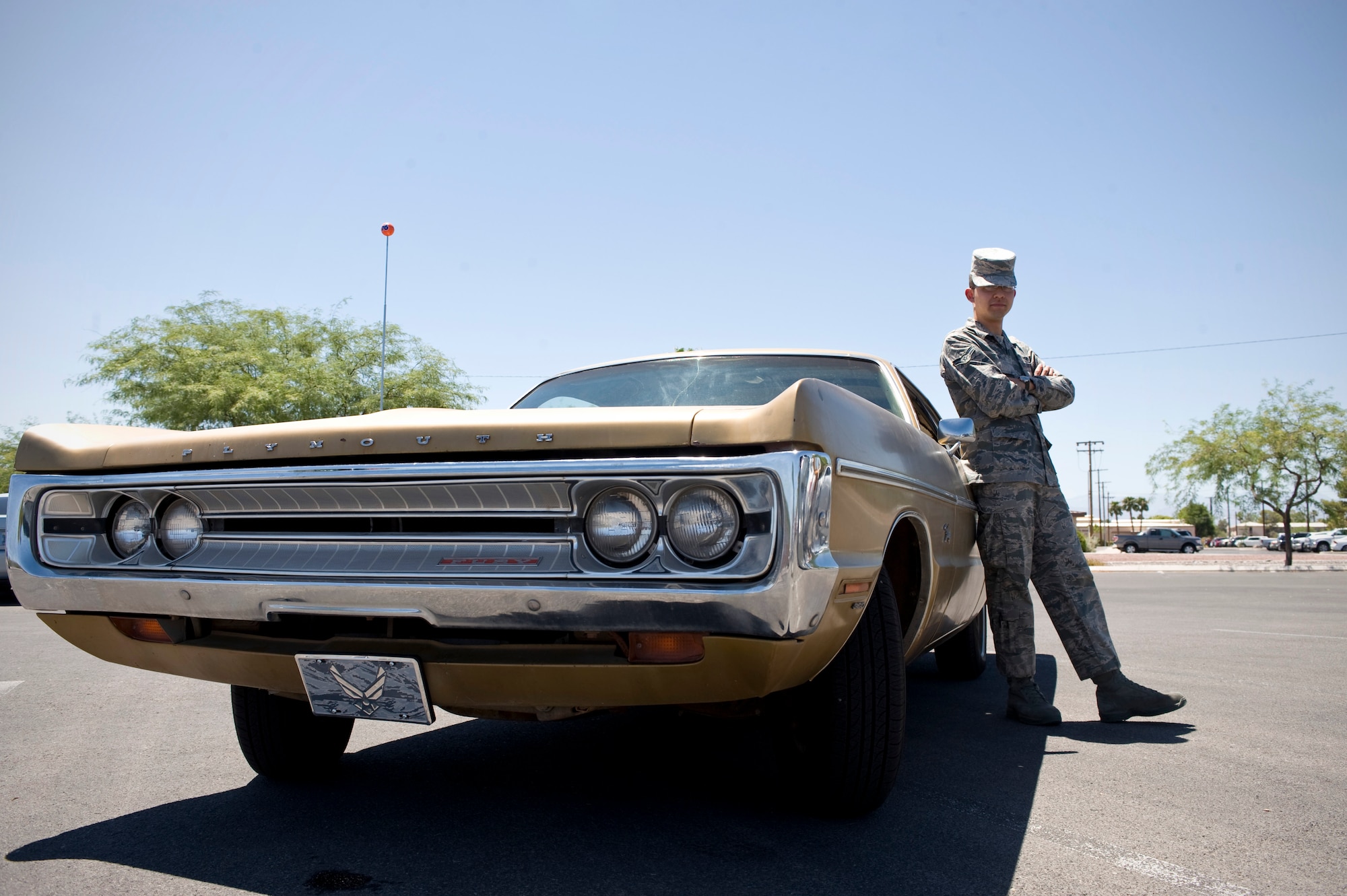 Airman 1st Class Thomas Kelly, 99th Comptroller Squadron customer service technician, stands next to his car “Fury” on Nellis Air Force Base, Nev., July 27. Kelly grew up fixing and tinkering with anything from 1940’s radio equipment to teletype machines to older Chrysler cars. Kelly is the third owner of the vehicle and hopes
to fully restore it in the future. (U.S. Air Force photo by Airman 1st Class Rachel Loftis)