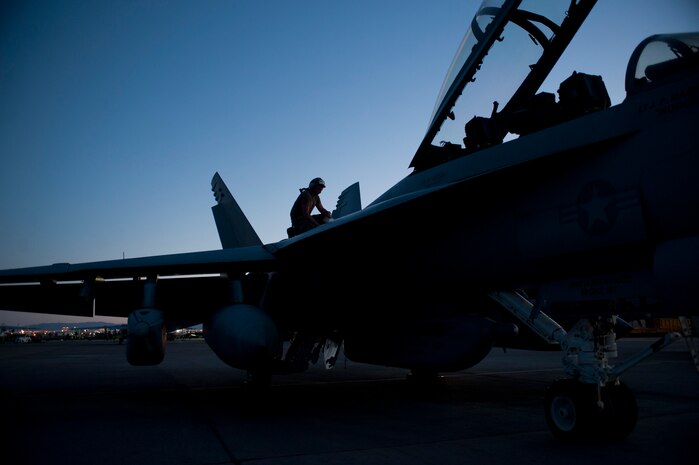 A U.S. Navy Airman assigned to Electronic Attack Squadron 138, Naval Air Station Whidbey Island, Wash., inspects an EA-18G Growler during Red Flag 15-3 at Nellis Air Force Base, Nev., July 28, 2015. Night missions have been integrated into Red Flag to prepare aircrews for missions in low-light environments. (U.S. Air Force photo by Airman 1st Class Mikaley Towle)