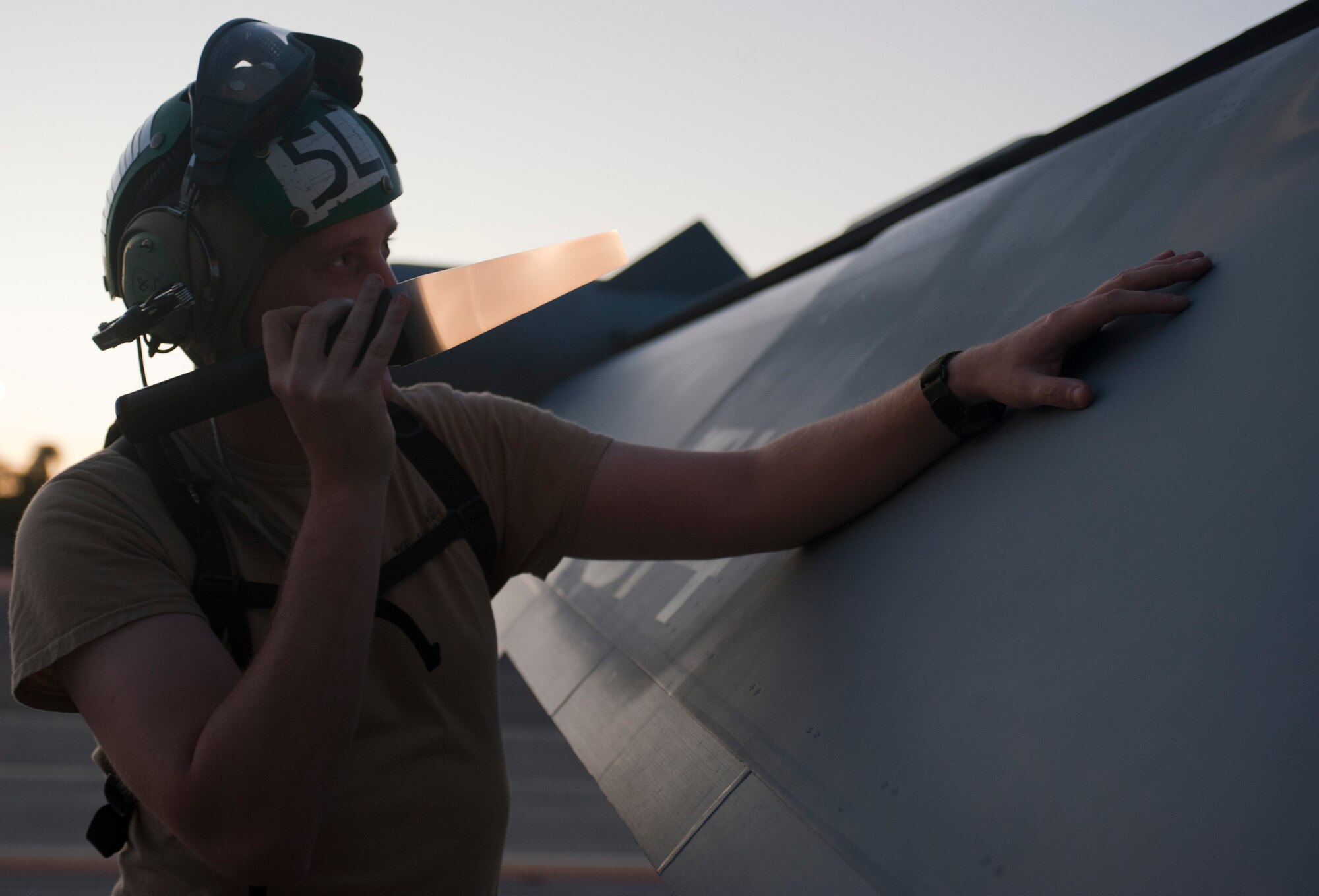 U.S. Navy Petty Officer 2nd Class Scott Flaminio, a plane captain assigned to Electronic Attack Squadron 138, Naval Air Station Whidbey Island, Wash., inspects an EA-18G Growler during Red Flag 15-3 at Nellis Air Force Base, Nev., July 28, 2015. Flaminio checks for any defects to help ensure that the aircraft is flyable. (U.S. Air Force photo by Airman 1st Class Mikaley Towle)