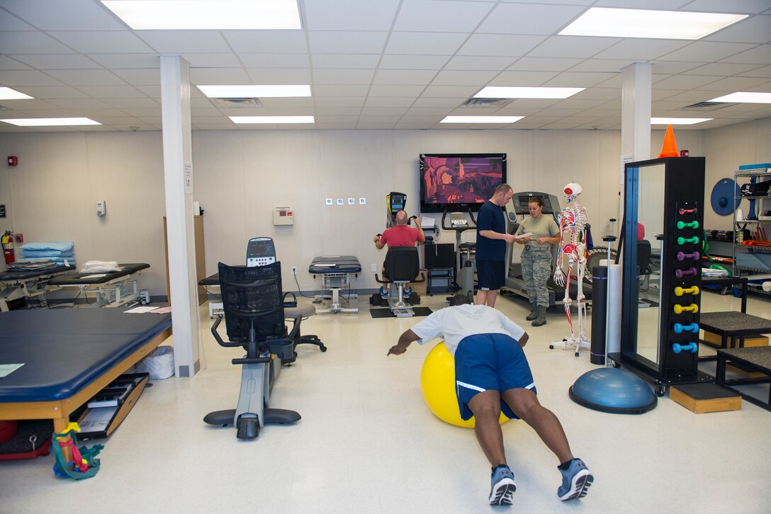 The 23d Medical Operations Squadron clinical medicine flight technicians assist patient’s during routine appointments July 30, 2015, at Moody Air Force Base, Ga. The clinic ensures readiness as Airmen recover, while training them on injury prevention, performing assessments and enhancements and educating them on injury rehabilitation. (U.S. Air Force photo by Airman Greg Nash/Released)