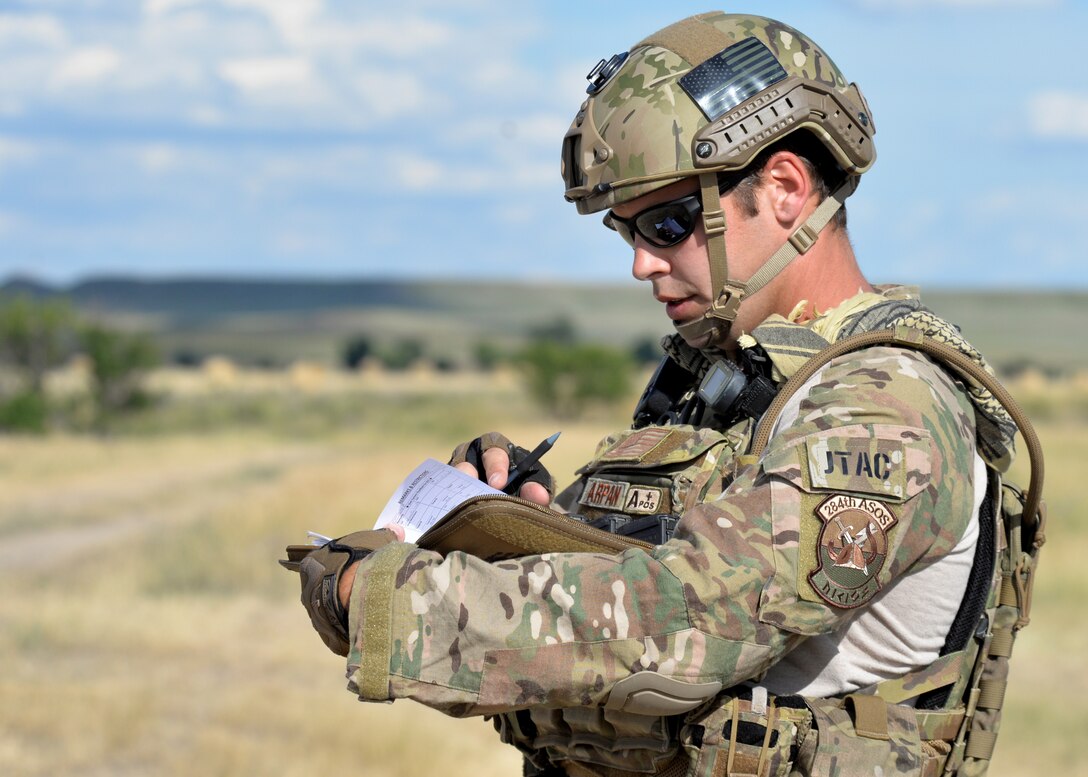 Kansas Air National Guard Staff Sgt. Brandon Arpan, 284th Air Support Operations Squadron assistant A-flight chief, documents the coordinates of targets during a close air support exercise in a training area near Alzada, Mont., July 20, 2015. During close air support missions, joint terminal air control members communicate with aircraft to inform them of the location of opposing forces. (U.S. Air Force photo by Senior Airman Rebecca Imwalle/Released)