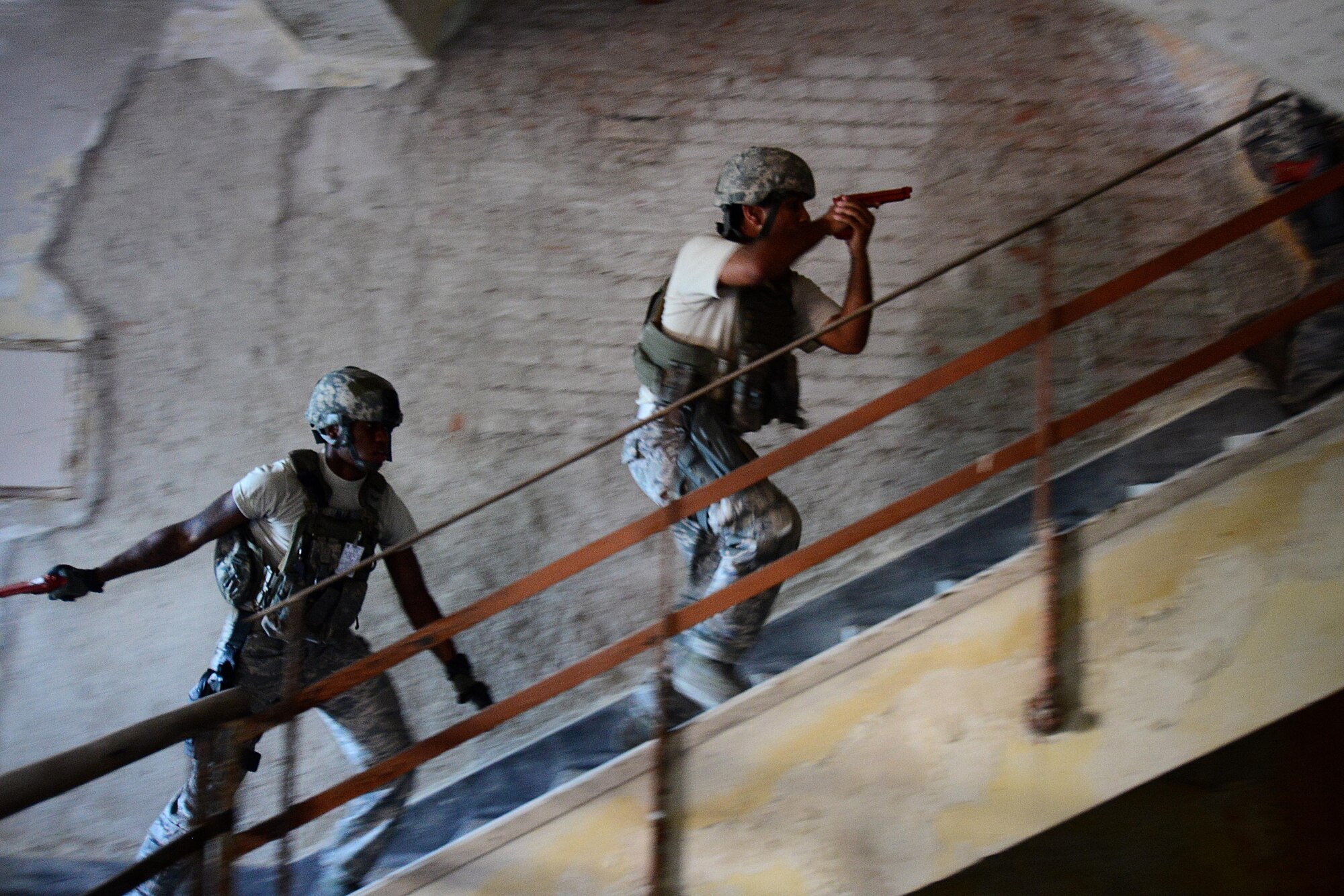 U.S. Air Force Airmen with the 31st Security Forces Squadron clear a room in an abandoned building July 30, 2015, at Aviano Air Base, Italy.  Approximately 20 defenders trained on breaching, clearing and other defensive and offensive tactics to prepare them for real-life situations. (U.S. Air Force photo by Staff Sgt. Evelyn Chavez/Released)