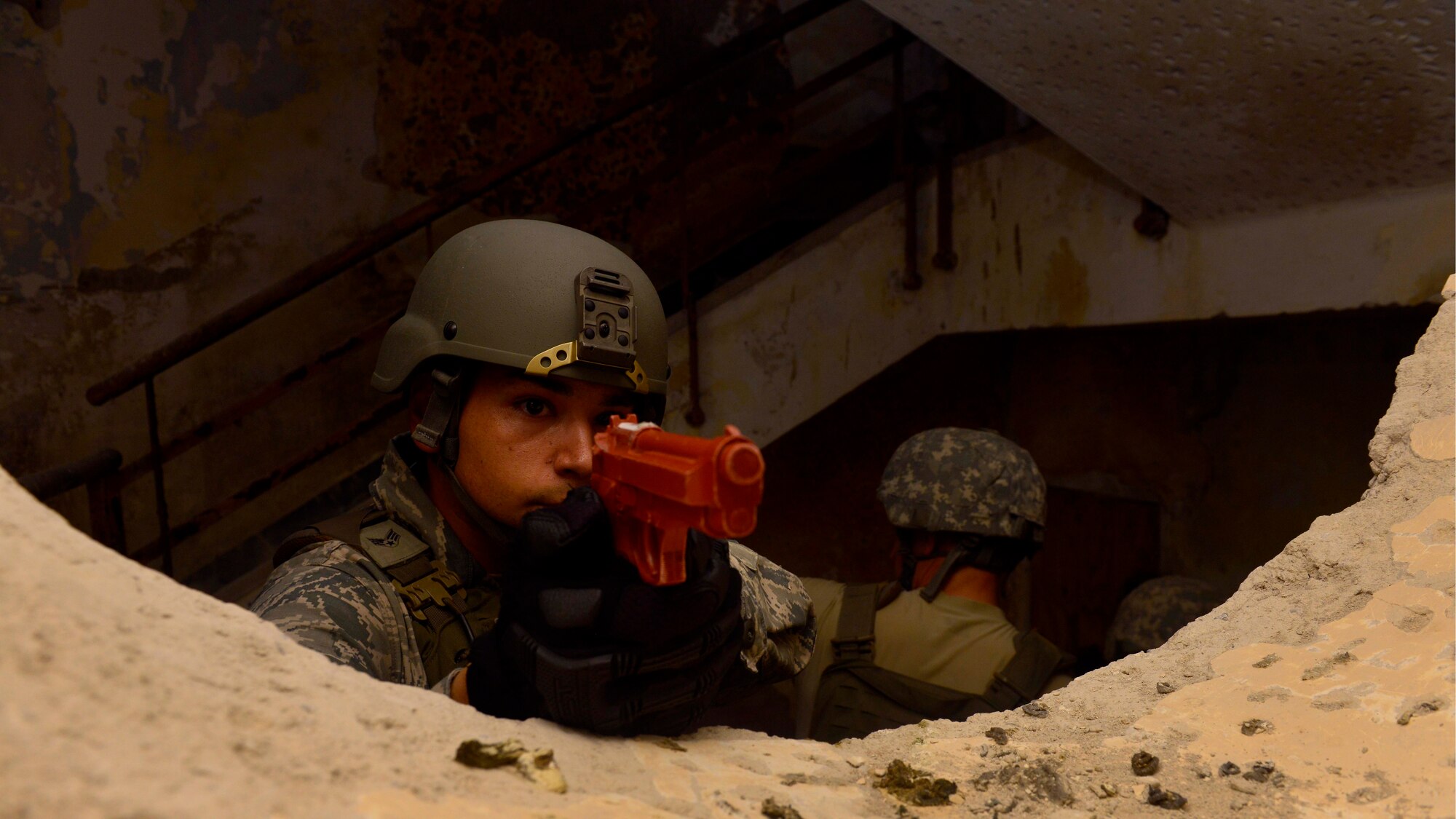 U.S. Air Force Senior Airman Joe Gonzalez, 31st Security Forces defender, provides security for his team during clearing training, July 30, 2015, at Aviano Air Base, Italy. Teams practiced offensive and defensive tactics to prepare themselves for real-life scenarios. (U.S. Air Force photo by Airman 1st Class Cary Smith/Released)