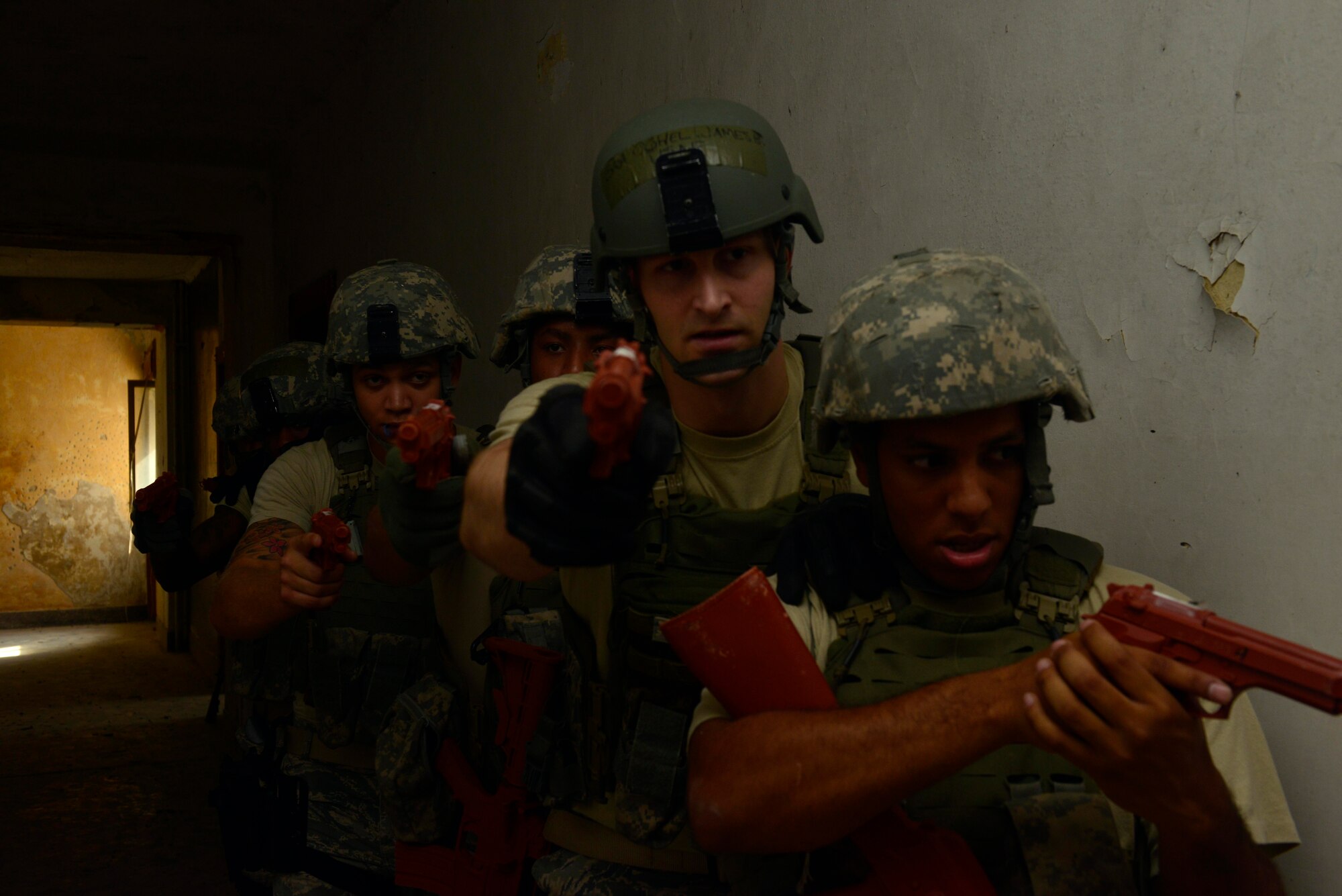 U.S. Air Force defenders secure a hallway during clearing training, July 30, 2015, at Aviano Air Base, Italy. The training consisted of different scenarios that defenders may encounter during a real world scenario. (U.S. Air Force photo by Airman 1st Class Cary Smith/Released)