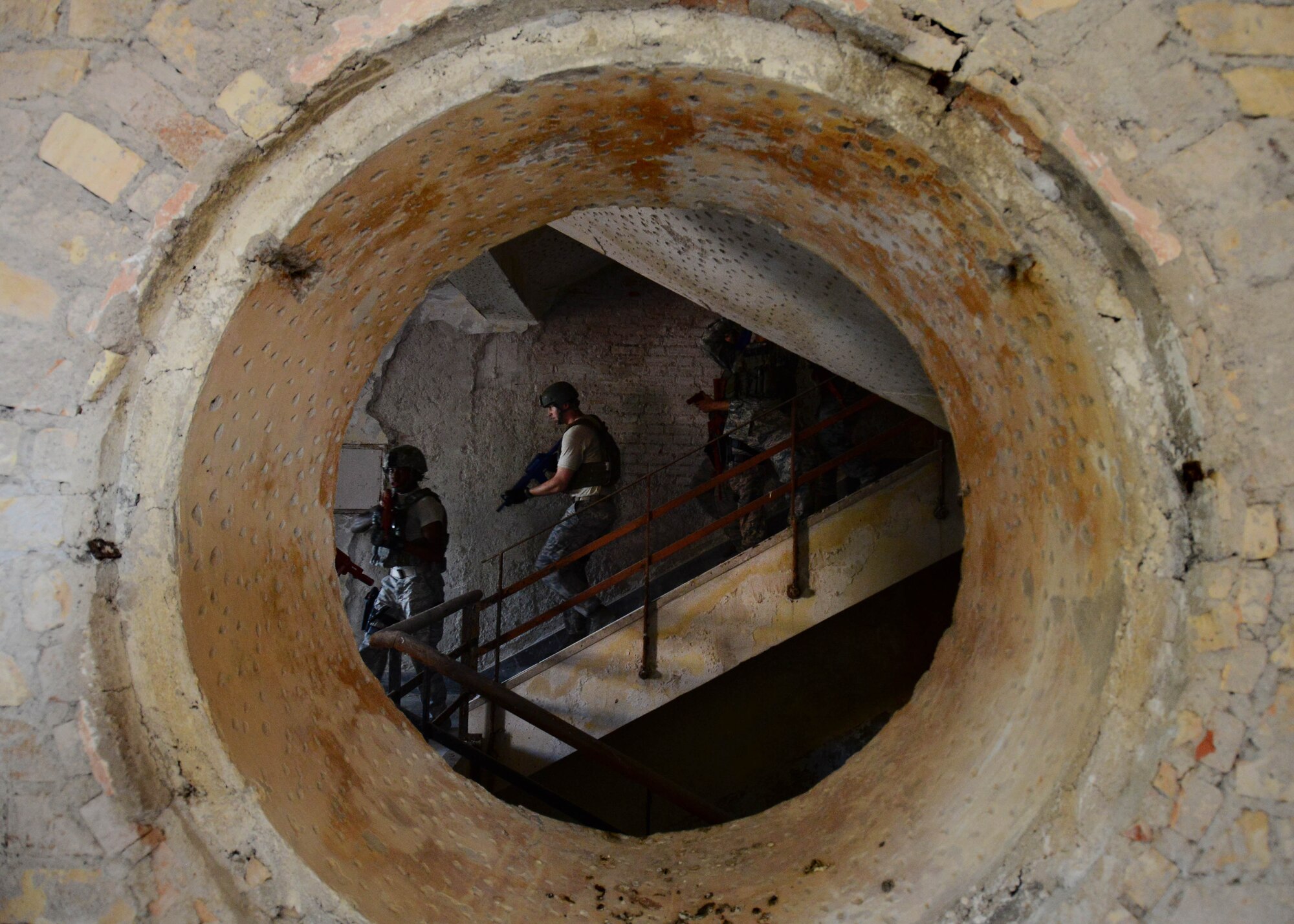 U.S. Air Force Airmen with the 31st Security Forces Squadron clear a room in an abandoned building July 30, 2015, at Aviano Air Base, Italy.  Approximately 20 defenders trained on breaching, clearing and other defensive and offensive tactics to prepare them for real-life situations. (U.S. Air Force photo by Staff Sgt. Evelyn Chavez/Released)