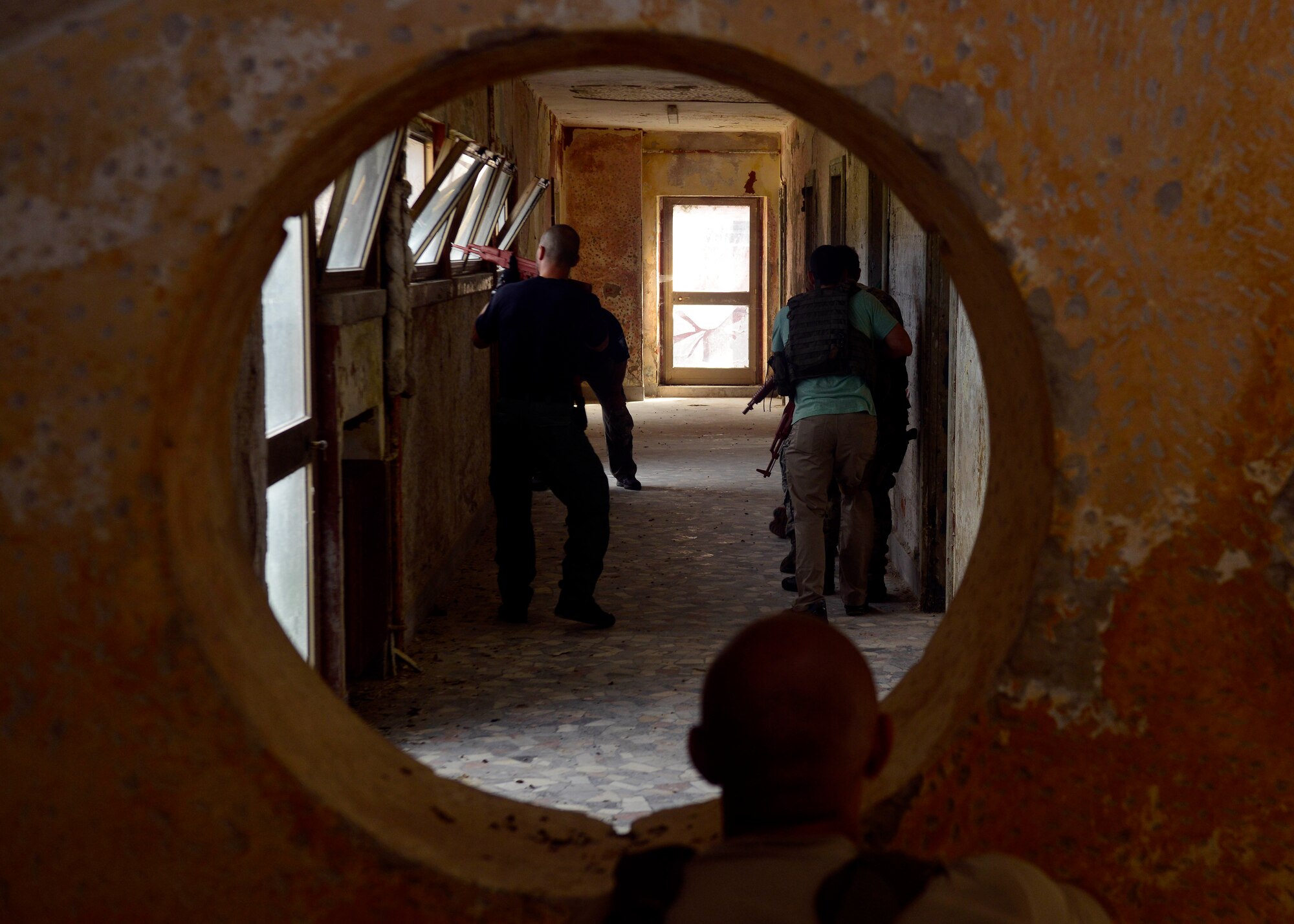 U.S. Air Force investigator Jerome Saunders, 31st Security Forces Squadron, watches a team perform security clearing training, July 30, 2015, at Aviano Air Base, Italy. The Airmen were trained on different scenarios they may encounter during a real-world situation. (U.S. Air Force photo by Airman 1st Class Cary Smith/Released)