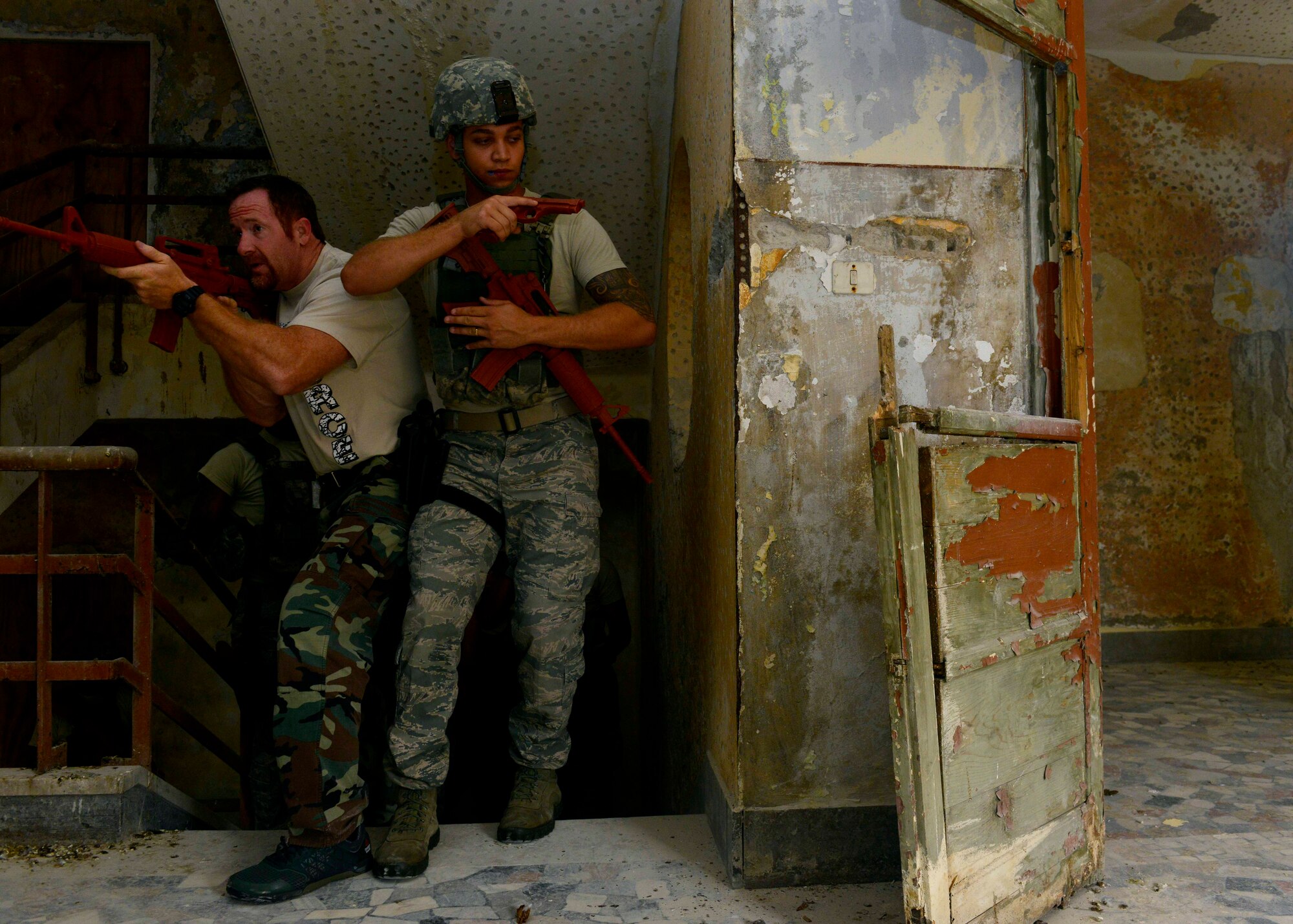 (From left) Heath Jackson, combat training instructor, and U.S. Air Force Senior Airman Deylin Cortellini, 31st Security Forces defender, enter a hallway during security clearing training with their team, July 30, 2015, at Aviano Air Base, Italy. Approximately 20 defenders participated in offensive and defensive tactics to help prepare themselves for real-life scenarios. (U.S. Air Force photo by Airman 1st Class Cary Smith/Released)