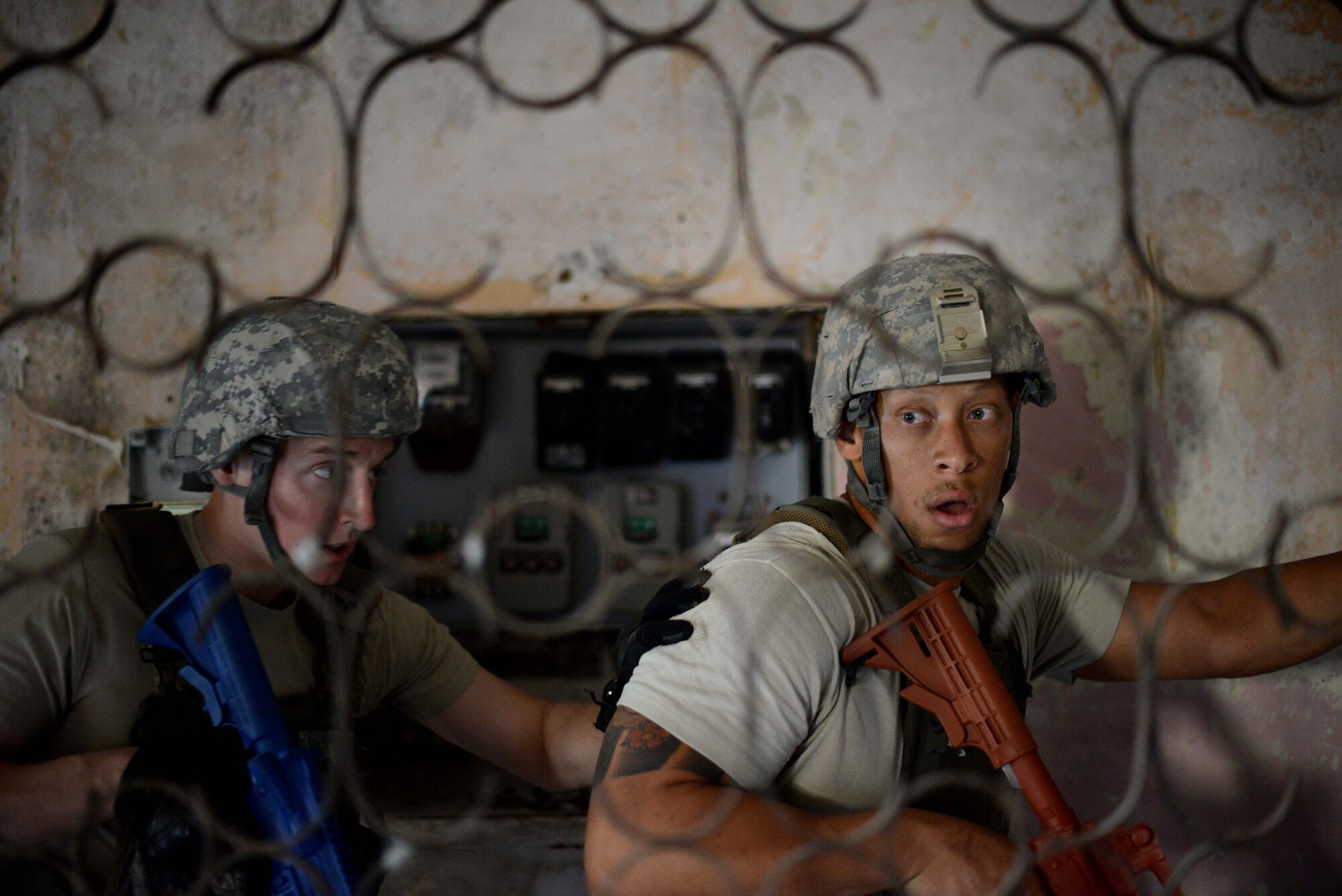 U.S. Air Force Airmen with the 31st Security Forces Squadron clear a room in an abandoned building July 30, 2015, at Aviano Air Base, Italy.  Approximately 20 defenders trained on breaching, clearing and other defensive and offensive tactics to prepare them for real-life situations. (U.S. Air Force photo by Staff Sgt. Evelyn Chavez/Released) 