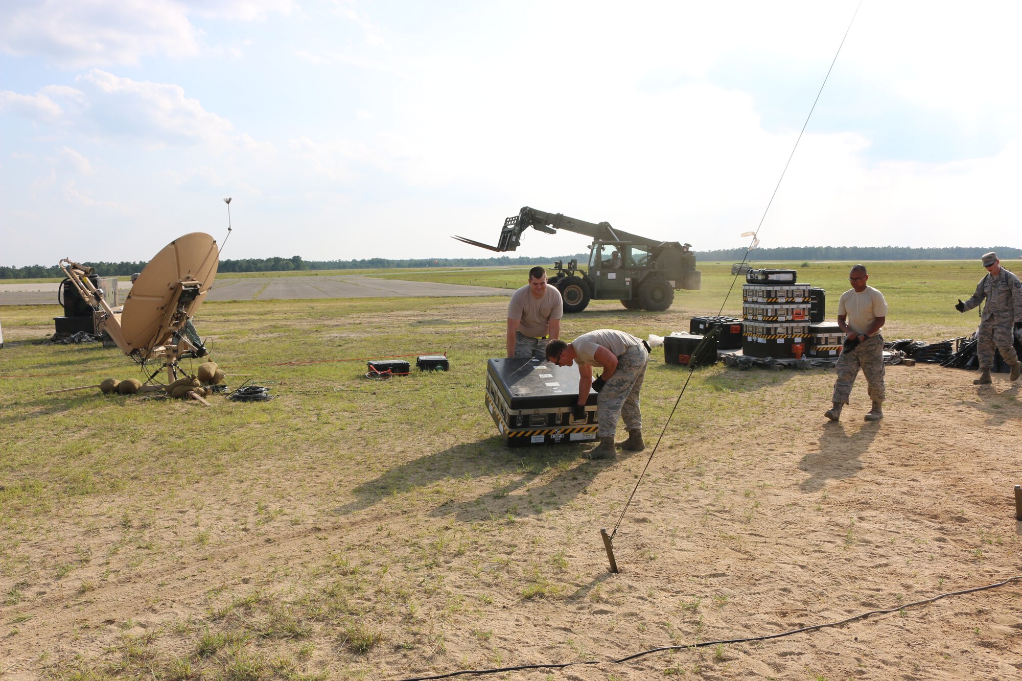 The first of 90 plane loads of cargo begins to arrive while service members set up tents and secure the base camp parameter during Exercise Turbo Distribution 15-7 at Joint Base McGuire-Dix-Lakehurst, N.J., July 18-24, 2015. (U.S. Army photo by Loran Doane/Released)
