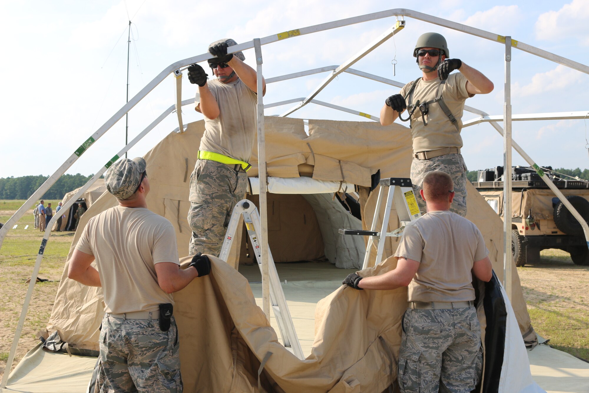 Airmen assemble sleep and work tents throughout the first day of Exercise Turbo Distribution 15-7 at Joint Base McGuire-Dix-Lakehurst, N.J., July 18, 2015. (U.S. Army photo by Loran Doane/Released)