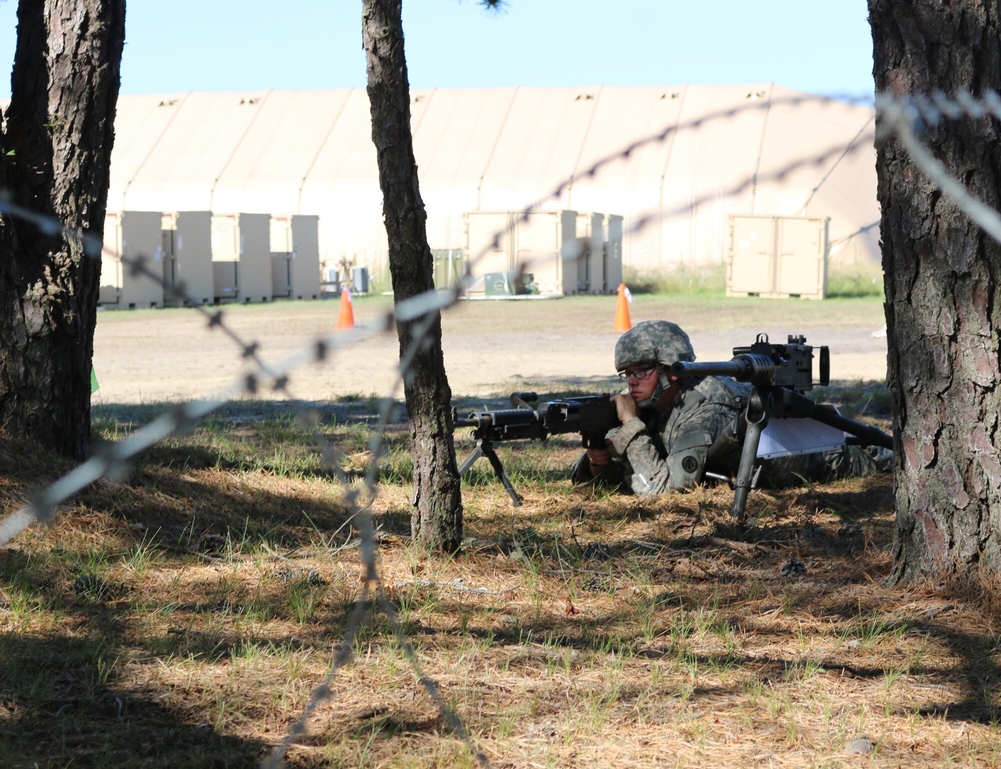 Soldiers man their defensive positions around the parameter of their base camp while responding to a simulated attack during Exercise Turbo Distribution 15-7 at Joint Base McGuire-Dix-Lakehurst, N.J., July 18-24, 2015. (U.S. Army photo by Loran Doane/Released)