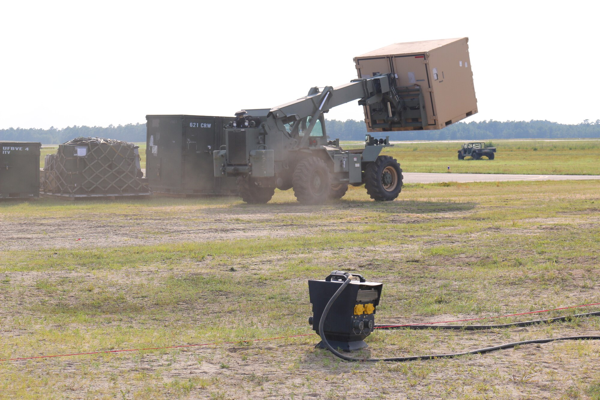 The first of 90 plane loads of cargo begins to arrive while service members set up tents and secure the base camp parameter during Exercise Turbo Distribution 15-7 at Joint Base McGuire-Dix-Lakehurst, N.J., July 18-24, 2015. (U.S. Army photo by Loran Doane/Released)