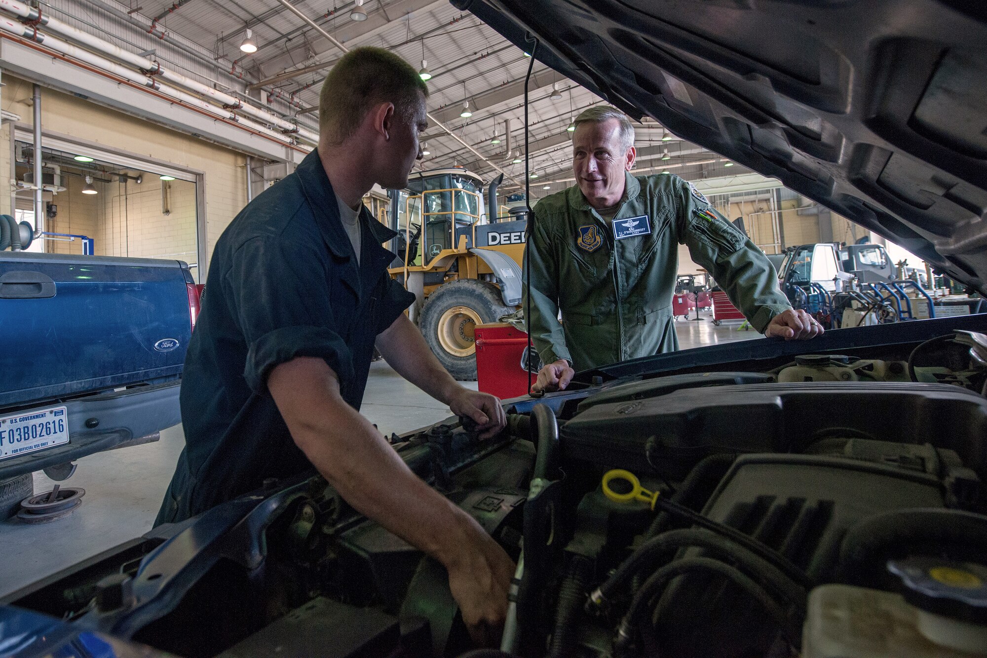 Airman 1st Class Cody Rolston, 8th Logistics Readiness Squadron special vehicle maintenance technician, troubleshoots an exhaust leak on a government vehicle as Lt. Gen. Terrence O'Shaughnessy, 7th Air Force and Air Component Command U.S. Forces Korea/U.S. Combined Forces commander, looks on, at Kunsan Air Base, Republic of Korea, July 31, 2015. During O’Shaughnessy’s two-day visit, he saw first-hand how the Wolf Pack contributes to deterring aggression on the peninsula. (U.S. Air Force photo by Senior Airman Katrina Heikkinen/Released)