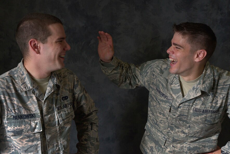 U.S. Air Force Senior Airmen Jarek Pankowski, 35th Logistics Readiness Squadron cargo specialist and Andrzej Pankowski, 35 LRS traffic management journeyman, laugh during a photo shoot at Misawa Air Base, Japan, July 31, 2015. Although they are only one year apart in age, their personalities are very different. Jarek is more soft-spoken, while his younger brother Andrzej is more outgoing. The two were reunited at Misawa after being separated for nearly 10 years. (U.S. Air Force photo by Senior Airman Patrick S. Ciccarone/Released)