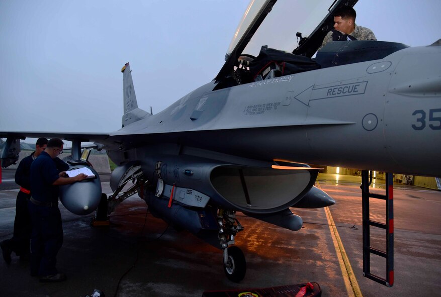 Crew chiefs from the 35th Aircraft Maintenance Squadron perform a post-flight inspection on an F-16 Fighting Falcon at Misawa Air Base, Japan, July 28, 2015. If aircraft malfunctions occur, crew chiefs either conduct maintenance themselves or request assistance from a specialty shop. (U.S. Air Force photo by Airman 1st Class Jordyn Fetter/Released)