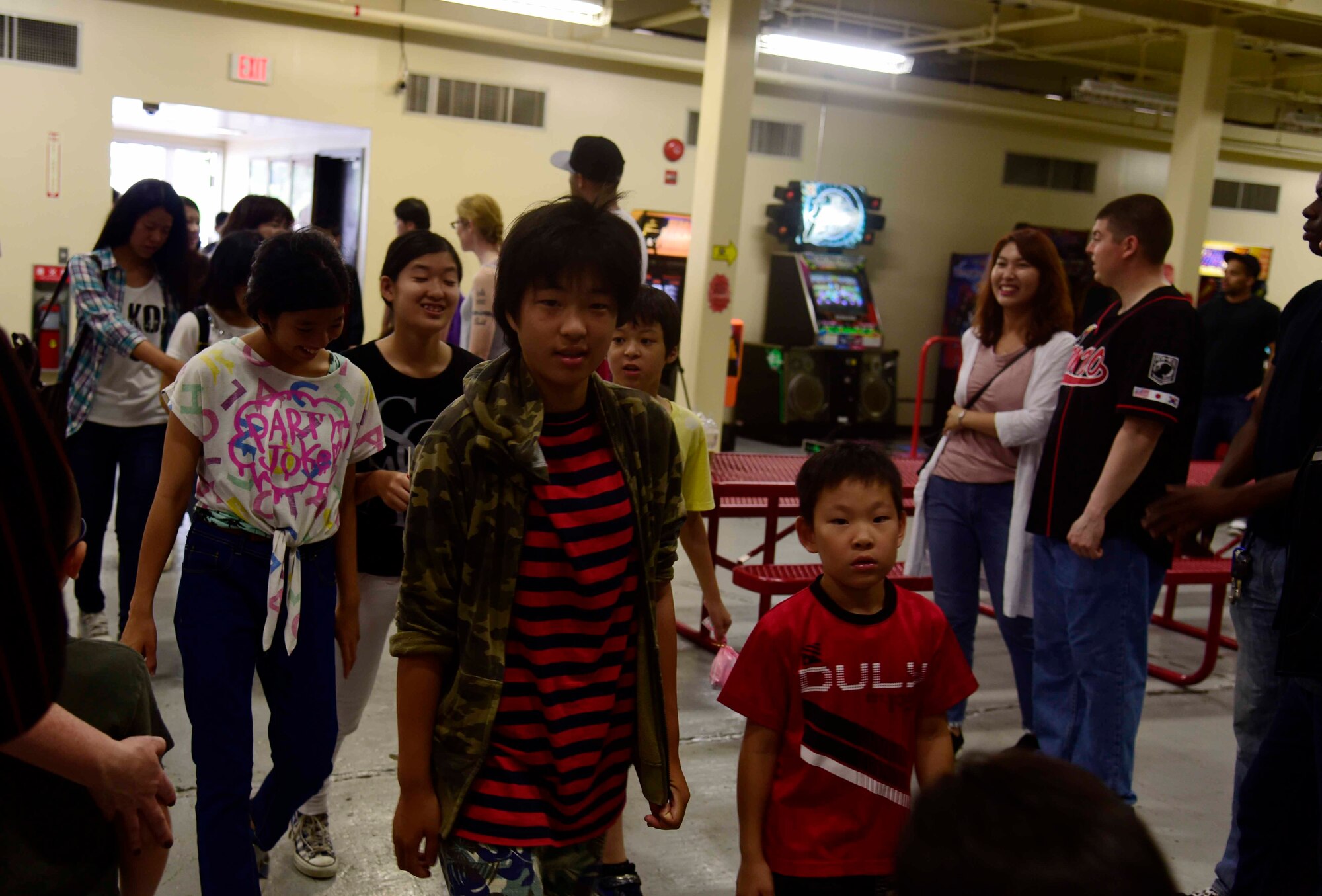 Children from the Shichinohe Children’s Home are welcomed by U.S. Air Force Airmen and families at Misawa Air Base, Japan, July 25, 2015. The event, hosted by the 35th Maintenance Squadron munitions flight, provided 45 children the chance to play games at the Weasel’s Den, an indoor recreation center, with Airmen from across Misawa AB. (U.S. Air Force photo by Airman 1st Class Jordyn Fetter/Released)