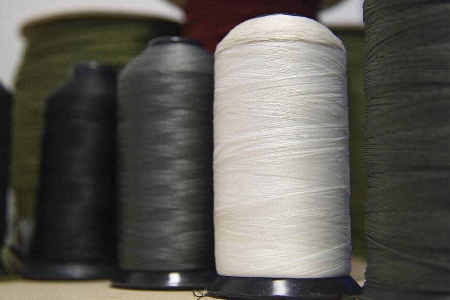 Ready-to-use sppols of rope sit at the 374th Operations Support Squadron aircrew flight equipment shop at Yokota Air Base, Japan, July 29, 2015. The AFE Airmen have access to rope, cord and fabric to mend tears and to make patches for survival gear. (U.S. Air Force phot by Senior Airman Michael Washburn/Released)