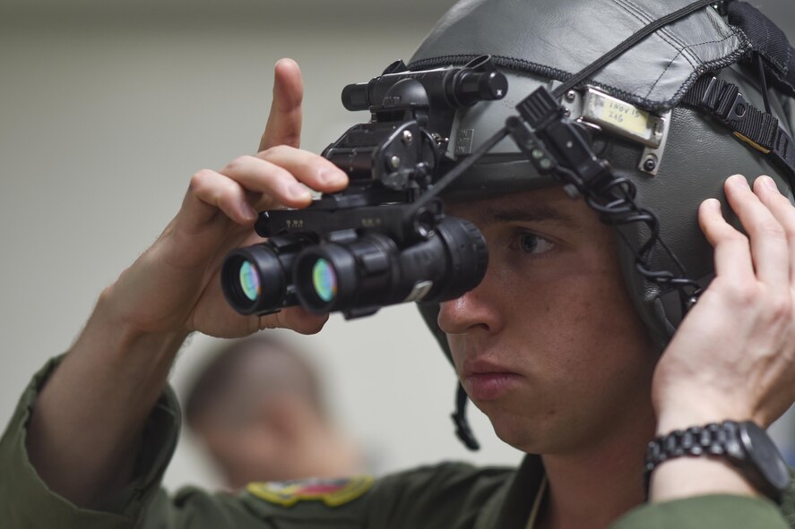 Capt. Jared Sullivan, 36th Airlift Squadron C-130 Hercules aircraft commander, adjusts a pair of night-vision goggles at Yokota Air Base, Japan, July 29, 2015. Aircrew flight equipment consists of anything from harnesses and helmets to parachutes and night-vision goggles, which need to be properly fitted before a nighttime mission. (U.S. Air Force phot by Senior Airman Michael Washburn/Released)