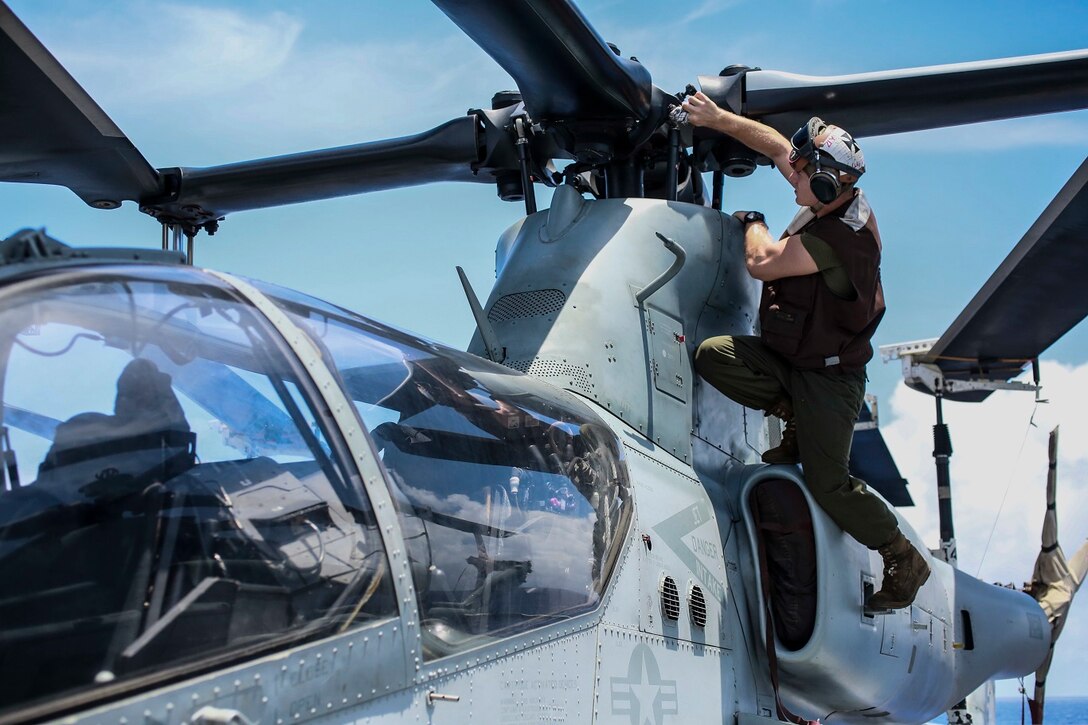 U.S. Marine Cpl. Ryan Gaedtke conducts corrosion prevention and treatment on an AH-1Z Viper aboard the USS Anchorage (LPD 23) at sea in the Pacific Ocean, May 28, 2015. Gaedtke is a helicopter mechanic with Marine Medium Tiltrotor Squadron 161 (Reinforced), 15th Marine Expeditionary Unit. The Marines of the 15th MEU ensure their aircraft are ready to operate at all times. (U.S. Marine Corps photo by Cpl. Steve H. Lopez/Released)