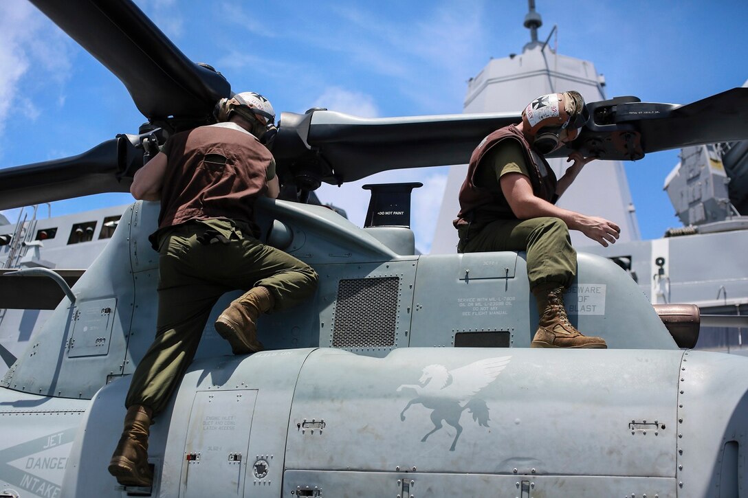 U.S. Marines Cpl. Ryan Gaedtke, left, and Lance Cpl. Corey Crowley conduct corrosion prevention and treatment on an AH-1Z Viper aboard the USS Anchorage (LPD 23) at sea in the Pacific Ocean, May 28, 2015. Both Gaedtke and Crowley are helicopter mechanics with Marine Medium Tiltrotor Squadron 161 (Reinforced), 15th Marine Expeditionary Unit. The Marines of the 15th MEU ensure their aircraft are ready to operate at all times. (U.S. Marine Corps photo by Cpl. Steve H. Lopez/Released)