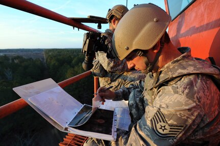 Louisiana Air National Guardsman Tech. Sgt. Andrew Guidry, a joint terminal attack controller for the 122nd Air Support Operations Squadron, references satellite images of proposed enemy targets before calling in air strike coordinates to Air Force Reserve pilots from the 47th Fighter Squadron flying A-10 Thunderbolts II (Warthogs), during a training exercise at the Claiborne Bombing and Gunnery Range near Woodworth, La., Jan. 19, 2011. This training helps JTACs sharpen their skills prior to deploying.