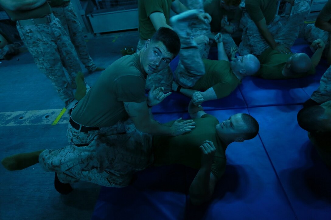 U.S. Marine Sgt. Matthew Ross, top, instructs Marines on individual techniques during Marine Corps Martial Arts Program training aboard the USS Anchorage (LPD 23) at sea in the Pacific Ocean, May 24, 2015. The Marines and Sailors aboard the Anchorage train constantly to prepare for their next assignment while deployed. (U.S. Marine Corps photo by Sgt. Jamean Berry/Released)