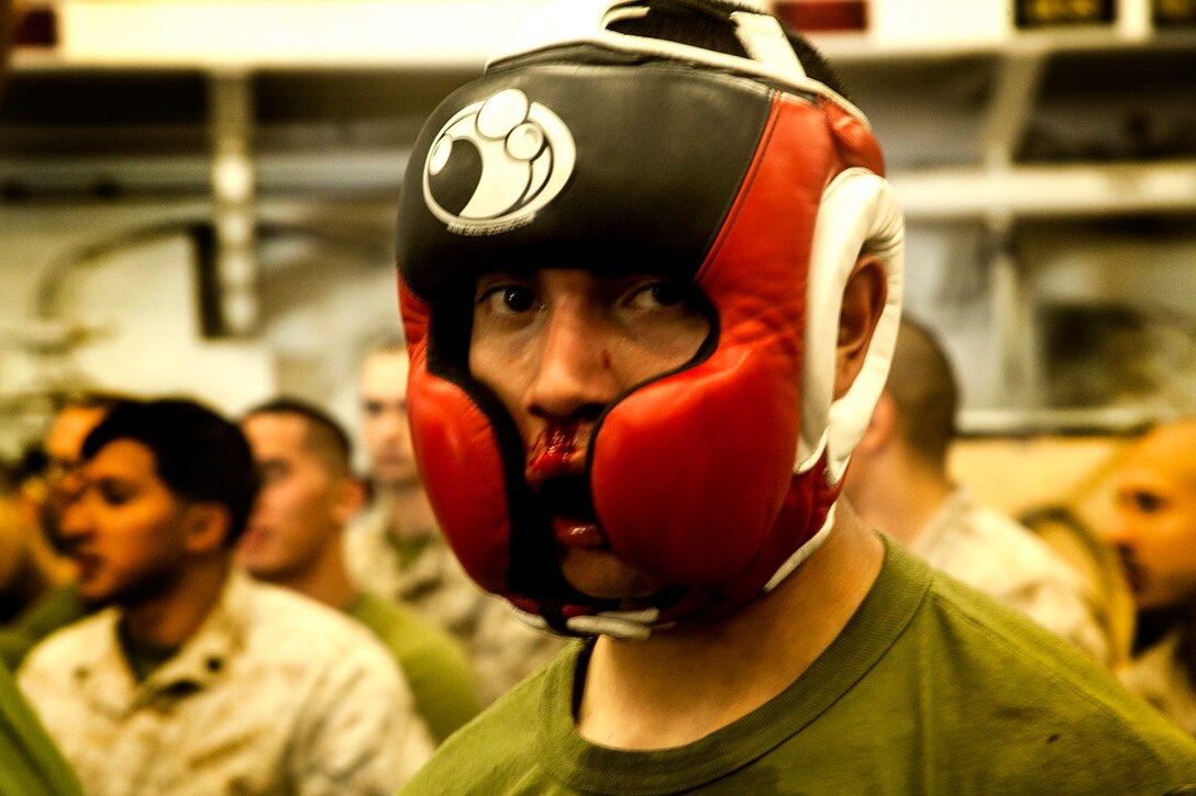 U.S. Marine Cpl. Roman Fernandez takes a breather between matches in the hangar bay of the USS Essex (LHD 2) at sea in the Pacific Ocean, May 29, 2015. Fernandez is a team leader with Lima Company, Battalion Landing Team 3rd Battalion, 1st Marine Regiment, 15th Marine Expeditionary Unit. The Marines find unique ways to continue to maintain combat readiness during their seven-month deployment through the Pacific and Central Command areas. (U.S. Marine Corps photo by Cpl. Elize McKelvey/released)