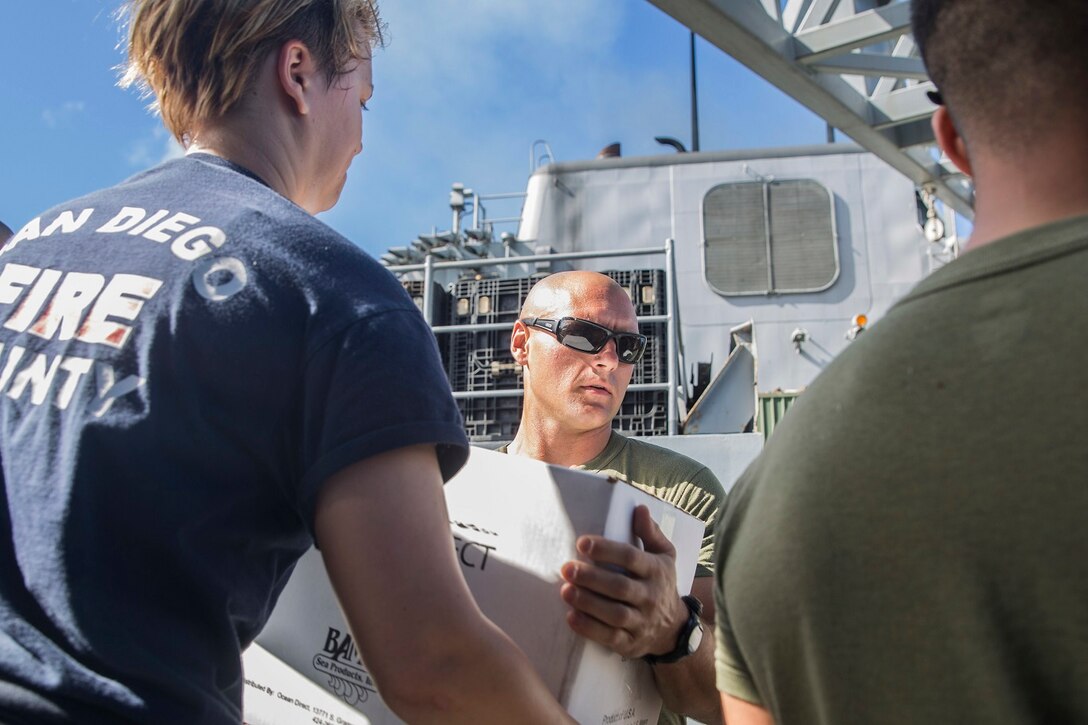U.S. Marine Sgt. Chad Skaggs helps offload supplies during replenishment at sea aboard the USS Rushmore (LSD 47) at sea in the Pacific Ocean, May 31, 2015. Skaggs is a squad leader with Kilo Company, Battalion Landing Team 3rd Battalion, 1st Marine Regiment, 15th Marine Expeditionary Unit. Marines and Sailors worked together to off load supplies and mail from loved ones. (U.S. Marine Corps photo by Sgt. Emmanuel Ramos/Released)