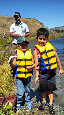 During the Spearfish Fishing Clinic at The Dalles Lock and Dam's Spearfish Park, hooking this trout left a smile from ear to ear for father and sons. (2013 Photo Contest)