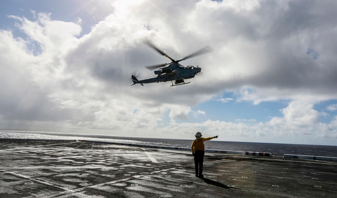 U.S. Navy Aviation Boatswain’s Aircraft Handling 3rd Class Joshua Naves guides an AH-1Z Viper off the flight deck aboard the USS Anchorage (LPD 23) at sea in the Pacific Ocean, May 30, 2015. Naves is an aircraft handler aboard the USS Anchorage. The Marines and Sailors of the 15th Marine Expeditionary Unit and Essex Amphibious Ready Group conduct flight operations to maintain expeditionary readiness. (U.S. Marine Corps photo by Cpl. Steve H. Lopez/Released)