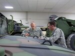 Staff Sgt. Travis Radtke, of Springfield, and Staff Sgt. Jason Copley, of
Plato, do preventative maintenance checks on vehicles at the Missouri
National Guard armory in Springfield. Missouri Gov. Jay Nixon declared a
state of emergency in Missouri on Monday and activated the Missouri National
Guard in preparation for a severe winter storm that is moving into the
region.