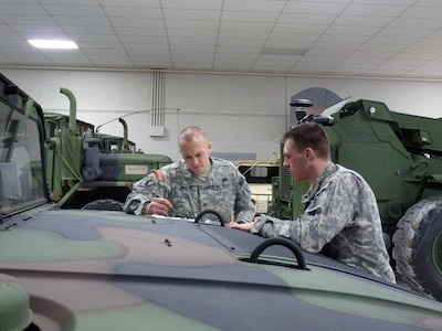 Staff Sgt. Travis Radtke, of Springfield, and Staff Sgt. Jason Copley, of
Plato, do preventative maintenance checks on vehicles at the Missouri
National Guard armory in Springfield. Missouri Gov. Jay Nixon declared a
state of emergency in Missouri on Monday and activated the Missouri National
Guard in preparation for a severe winter storm that is moving into the
region.