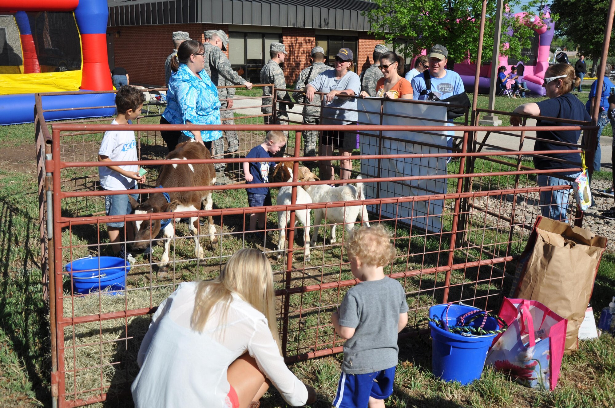 GOODFELLOW AIR FORCE BASE, Texas – Goodfellow youths and parents participate at the petting zoo during the Month of the Military Child "What's Your Story" Children's Fair event at the youth complex April 25. Youth Programs hosted the event to celebrate military children and present awards to the winners of the “What’s Your Story” essay contest. (U.S. Air Force photo/ Senior Airman Joshua Edwards)